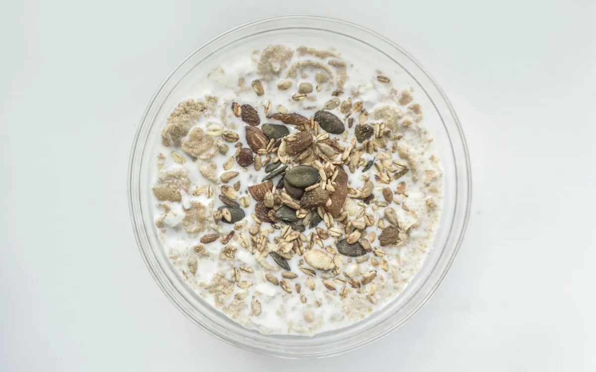 A bowl of oats with milk and mixed seeds; illustrative stock photo